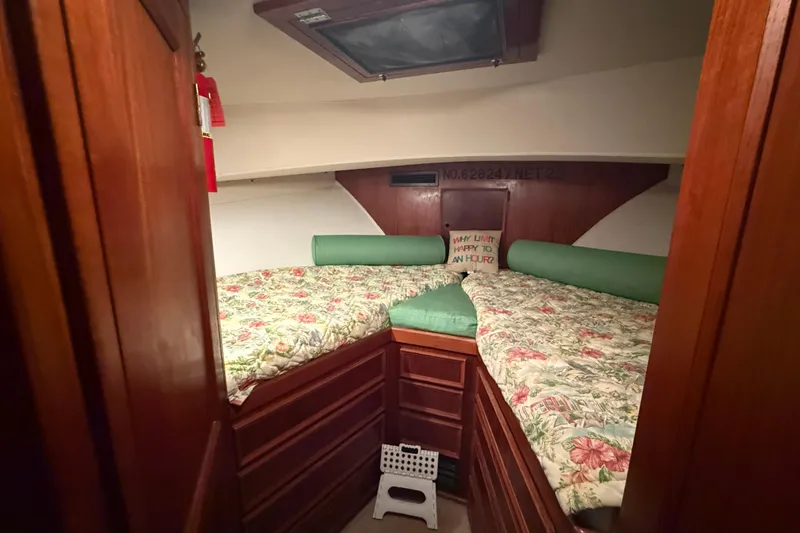 Slide: The Image of Cozy cabin interior of 1980 Hatteras 42 LRC with floral bedding and wooden cabinetry. - 25