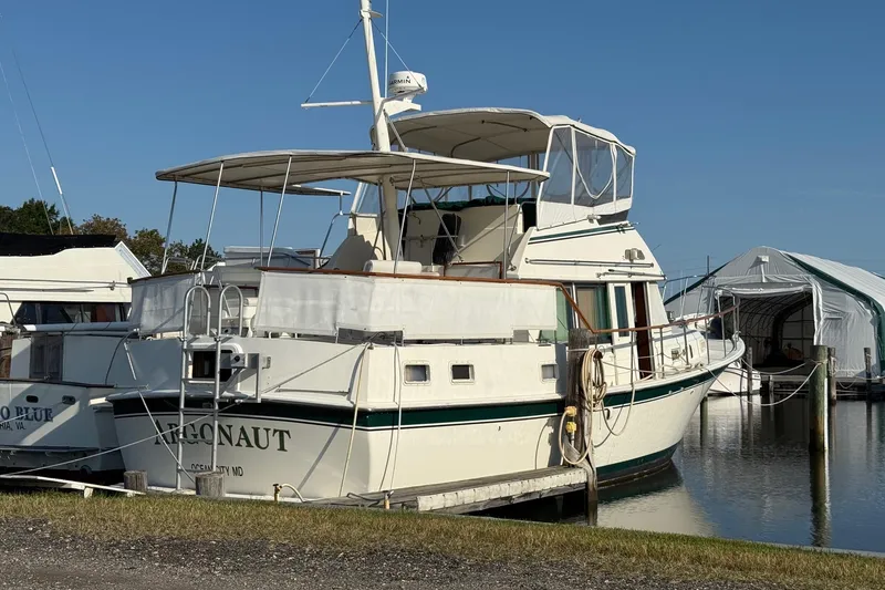 Slide: The Image of 1980 Hatteras 42 LRC yacht docked at marina under clear blue sky. - 26