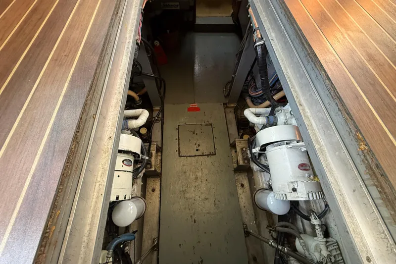 Slide: The Image of Engine room of 1980 Hatteras 42 LRC yacht, showcasing dual engines and mechanical components. - 29