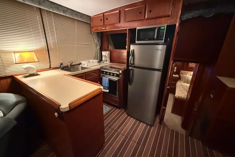 Slide: The Image of Interior of a 1980 Hatteras 42 LRC yacht with wood paneling and nautical decor. - 3