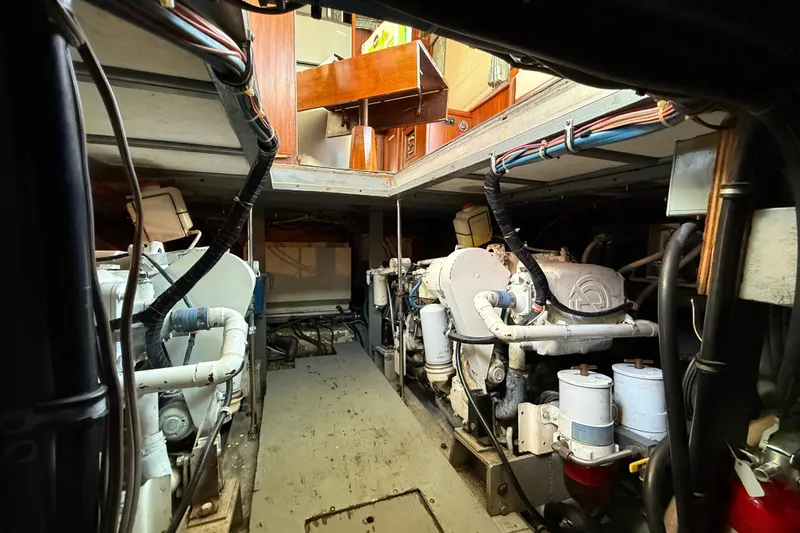 Slide: The Image of Engine room of a 1980 Hatteras 42 LRC yacht, showcasing dual engines and mechanical components. - 30