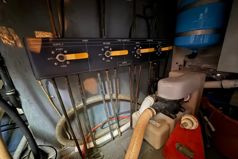 Slide: The Image of Engine room of 1980 Hatteras 42 LRC with fuel manifold and hoses. - 31