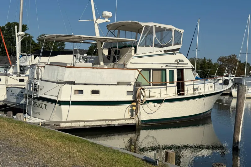 Slide: The Image of 1980 Hatteras 42 LRC yacht docked at marina under clear blue sky. - 39