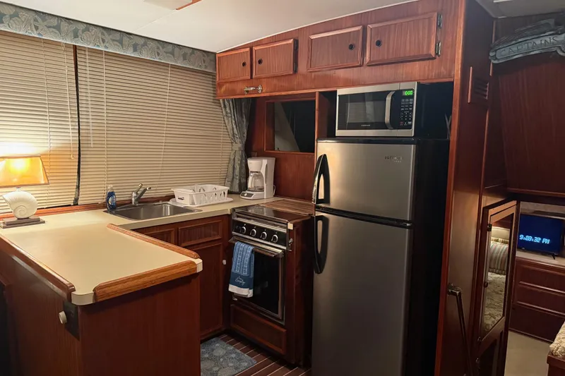 Slide: The Image of Interior of 1980 Hatteras 42 LRC yacht with cozy seating and wooden table. - 4