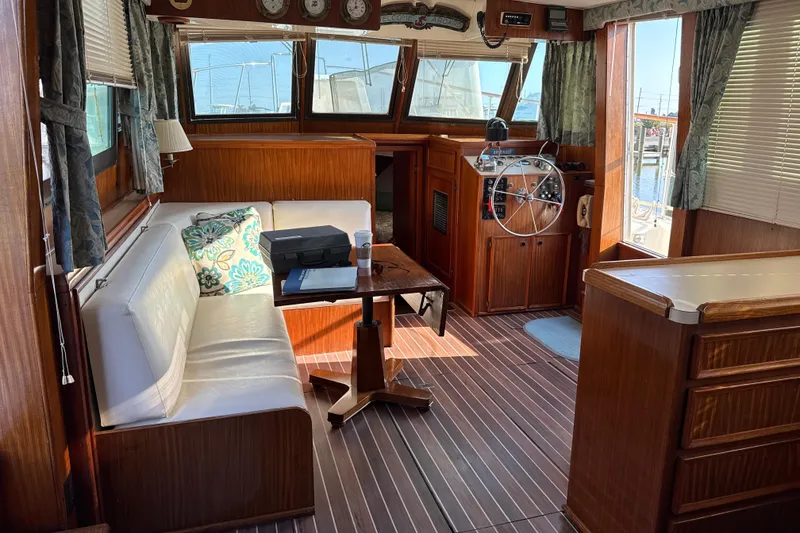 Slide: The Image of Interior of 1980 Hatteras 42 LRC yacht with wooden decor and steering wheel. - 40