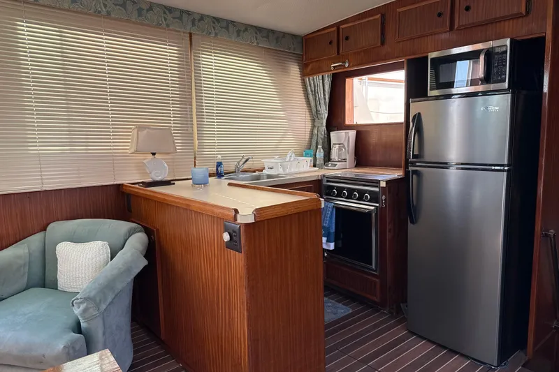 Slide: The Image of Interior of 1980 Hatteras 42 LRC yacht with kitchen and seating area. - 41