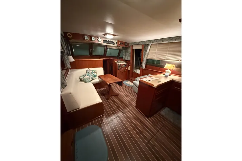 Slide: The Image of Interior of 1980 Hatteras 42 LRC yacht with cozy seating and wooden decor. - 43
