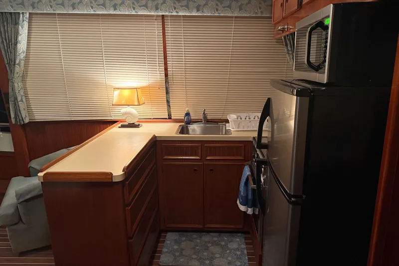 Slide: The Image of Interior of 1980 Hatteras 42 LRC yacht with cozy seating and nautical decor. - 5