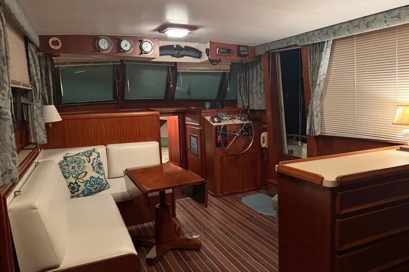 Slide: The Image of 1980 Hatteras 42 LRC yacht kitchen with wood cabinetry, stainless steel appliances, and cozy lighting. - 8