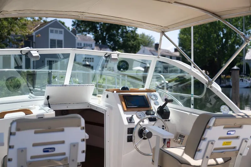Slide: The Image of 2004 Hunt Yachts Surfhunter 25 cockpit with steering wheel and navigation equipment. - 14
