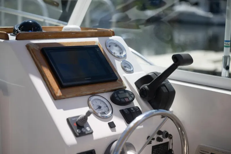 Slide: The Image of Control panel of 2004 Hunt Yachts Surfhunter 25 with navigation equipment and gauges. - 19