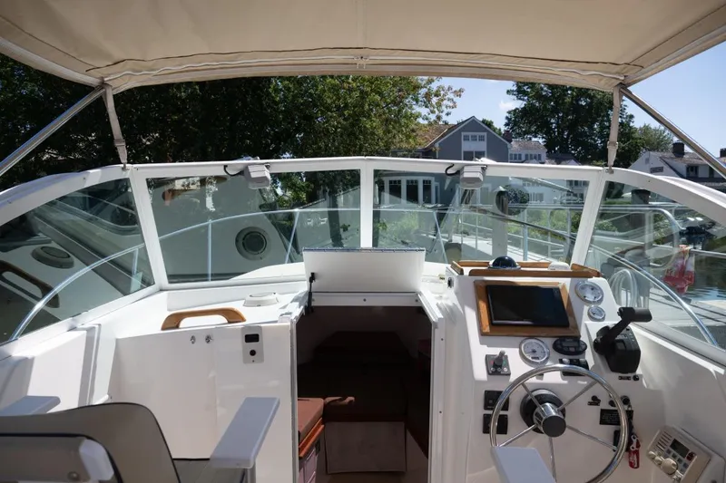 Slide: The Image of 2004 Hunt Yachts Surfhunter 25 cockpit with steering wheel and navigation instruments. - 22