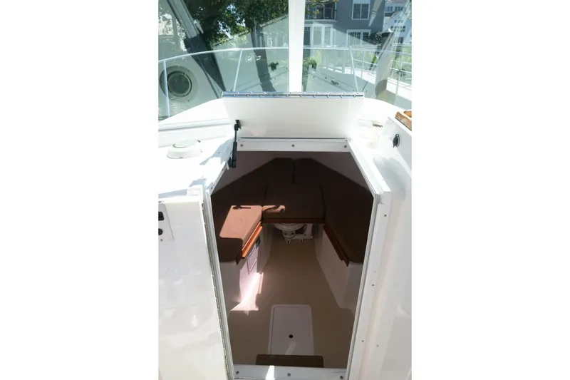 Slide: The Image of 2004 Hunt Yachts Surfhunter 25 cabin interior with seating and storage. - 24