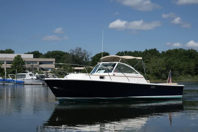 Slide: The Image of 2004 Hunt Yachts Surfhunter 25 boat on calm water under blue sky. - 36