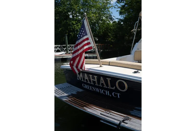 Slide: The Image of 2004 Hunt Yachts Surfhunter 25 with American flag, docked in Greenwich, CT. - 6