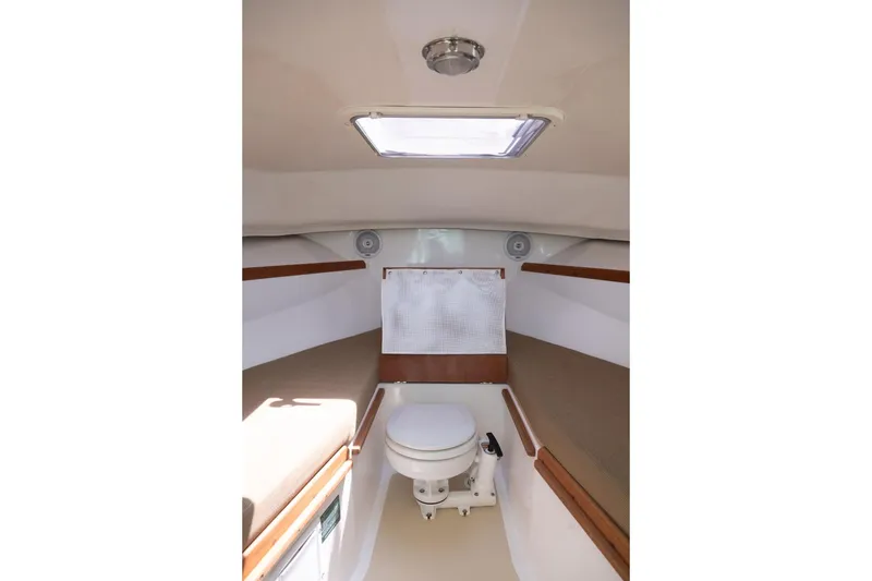 Slide: The Image of 2004 Hunt Yachts Surfhunter 25 cabin interior with toilet and seating. - 26