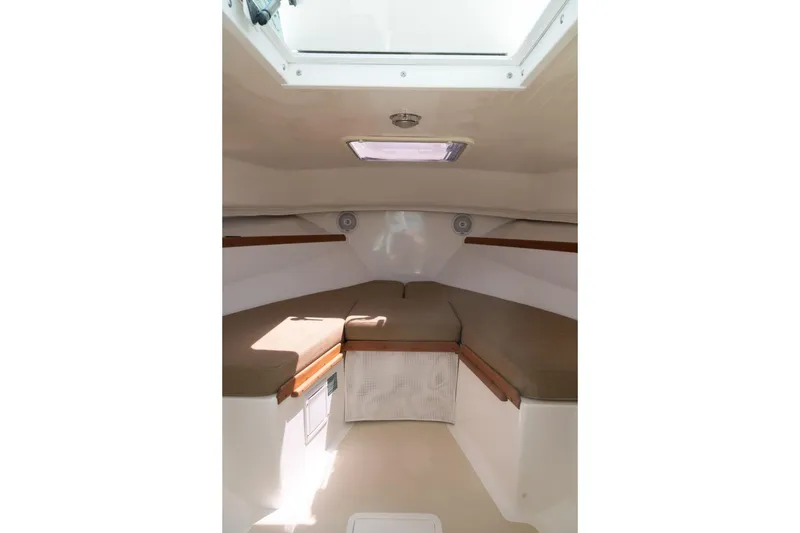 Slide: The Image of Interior cabin of 2004 Hunt Yachts Surfhunter 25 with cushioned seating and overhead hatch. - 32