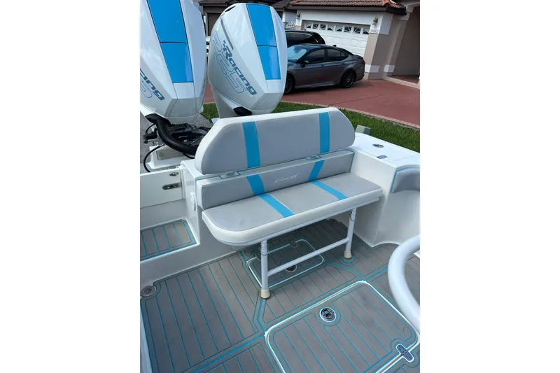 Slide: The Image of 2019 Concept 27' CC boat interior with blue-accented seating and twin engines. - 13