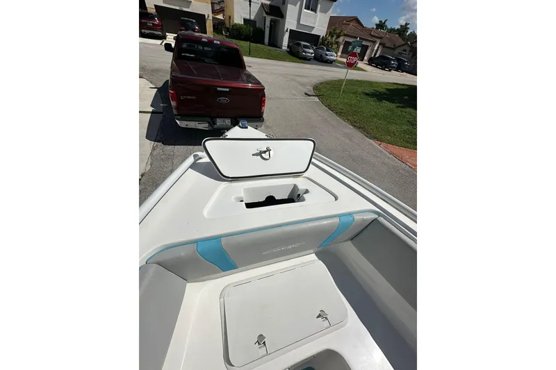 Slide: The Image of 2019 Concept 27' CC boat on trailer, parked behind a red truck. - 21