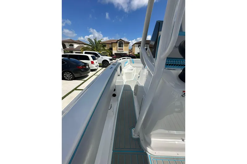Slide: The Image of 2019 Concept 27' CC boat parked in a residential driveway under a clear blue sky. - 29