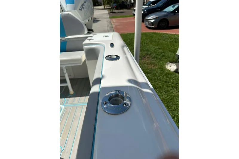 Slide: The Image of 2019 Concept 27' CC boat interior with rod holders and seating, parked outdoors. - 31