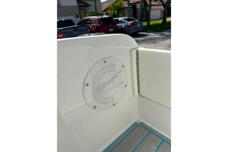 Slide: The Image of 2019 Concept 27' CC boat interior with logo detail, parked in residential area. - 8