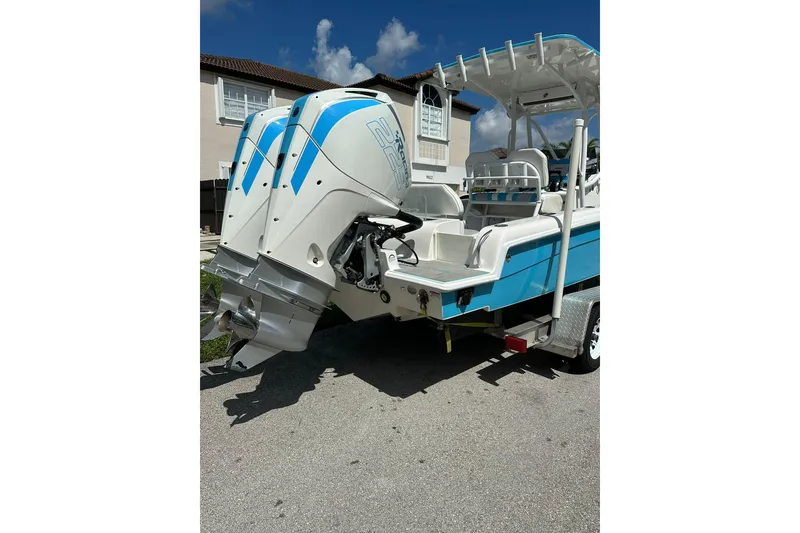 Slide: The Image of 2019 Concept 27' CC boat with dual outboard engines, parked on a trailer. - 9