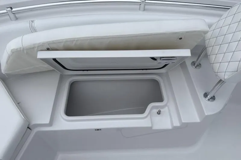 Slide: The Image of 2026 Sportsman Heritage 231 Center Console boat storage compartment with cushioned seating. - 10
