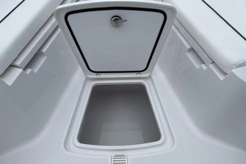 Slide: The Image of 2026 Sportsman Heritage 231 Center Console storage compartment, open and empty. - 13