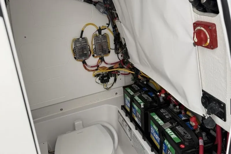 Slide: The Image of 2026 Sportsman Heritage 231 Center Console battery compartment with wiring and electrical components. - 18