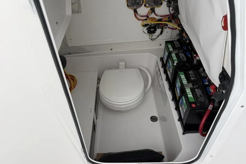 Slide: The Image of Interior of 2026 Sportsman Heritage 231 Center Console with toilet and battery storage. - 19