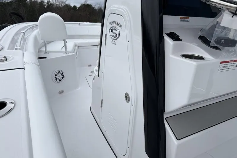 Slide: The Image of 2026 Sportsman Heritage 231 Center Console boat interior with seating and storage. - 21