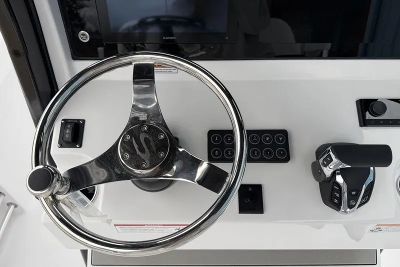 Slide: The Image of Steering console of 2026 Sportsman Heritage 231 Center Console boat, featuring modern controls. - 24