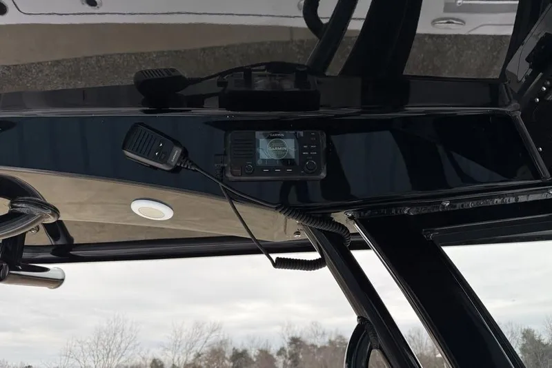 Slide: The Image of 2026 Sportsman Heritage 231 Center Console dashboard with Garmin device and microphone. - 25