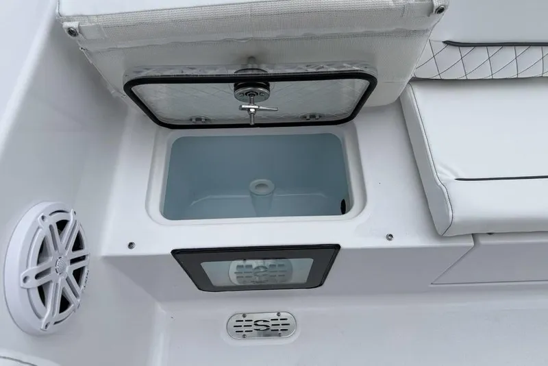 Slide: The Image of 2026 Sportsman Heritage 231 Center Console boat interior with storage compartment and speaker. - 29