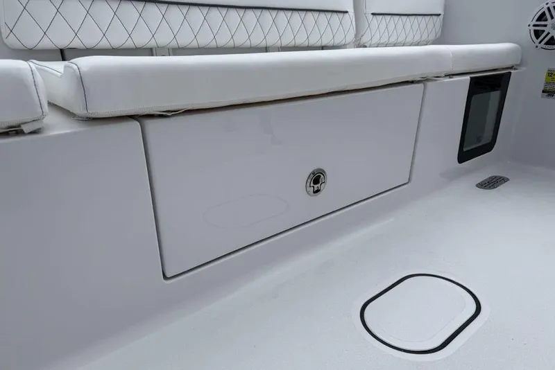 Slide: The Image of 2026 Sportsman Heritage 231 Center Console interior with cushioned seating and storage compartment. - 31