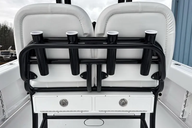 Slide: The Image of 2026 Sportsman Heritage 231 Center Console boat seating with rod holders and storage drawers. - 33