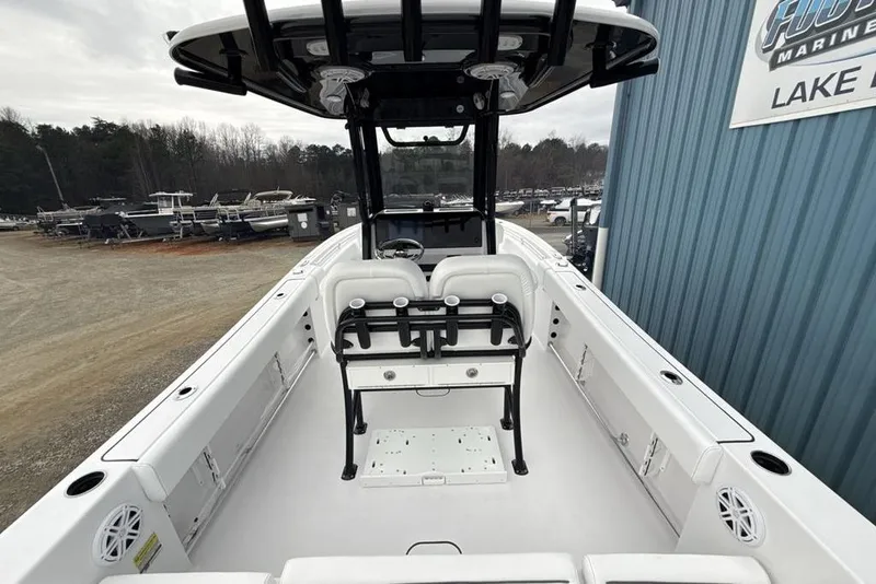 Slide: The Image of 2026 Sportsman Heritage 231 Center Console boat interior at marina, showcasing seating and console. - 36
