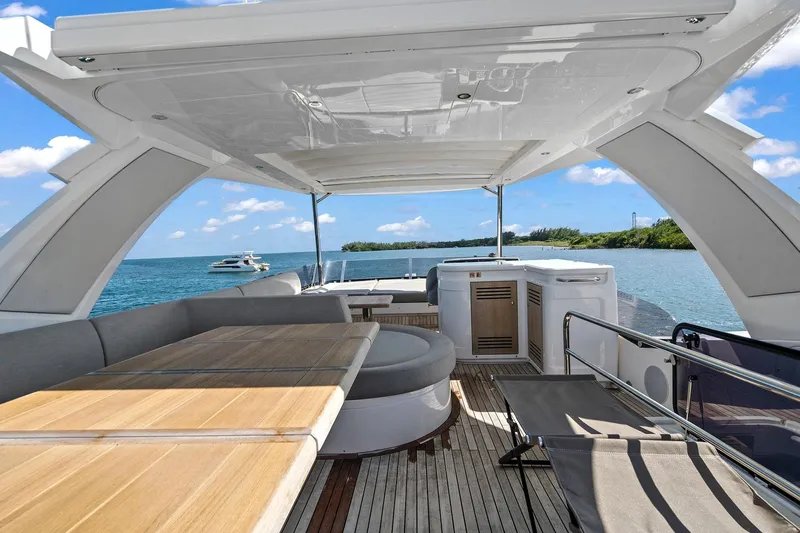 Slide: The Image of Luxurious Sunseeker Manhattan 66 yacht deck with seating, ocean view, and clear blue sky. - 11