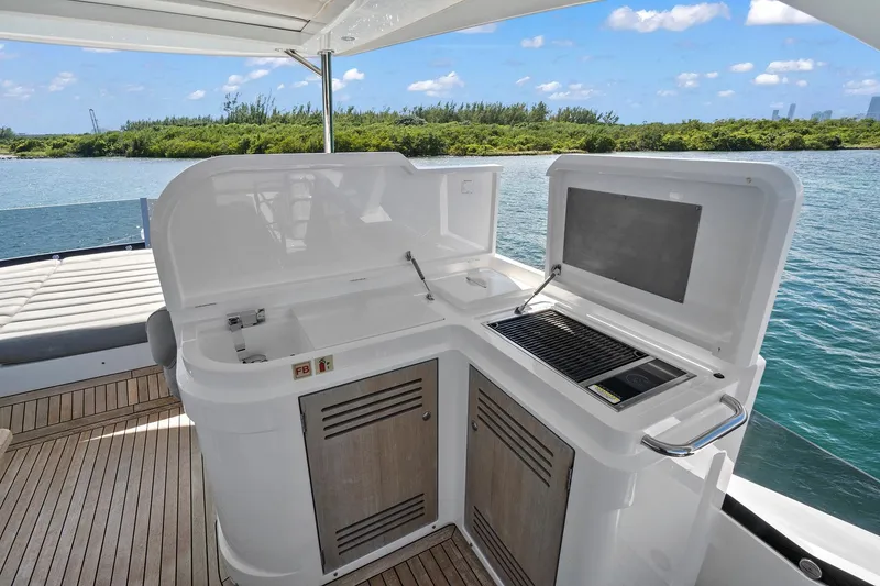 Slide: The Image of Outdoor kitchen on 2019 Sunseeker Manhattan 66 yacht with scenic water view. - 13