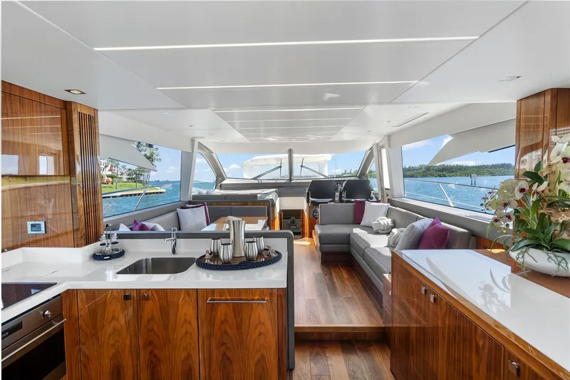 Slide: The Image of Luxurious interior of 2019 Sunseeker Manhattan 66 yacht with elegant wood finishes and scenic ocean view. - 15