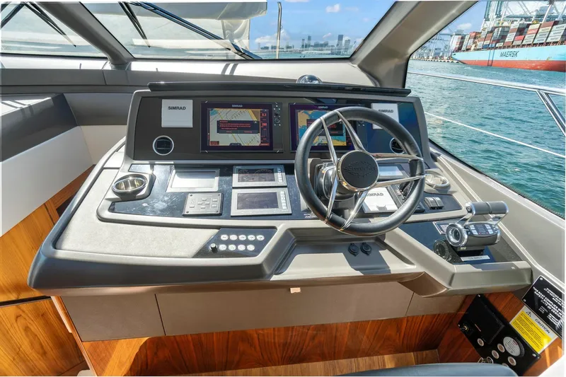 Slide: The Image of 2019 Sunseeker Manhattan 66 yacht helm with advanced navigation systems and controls. - 18