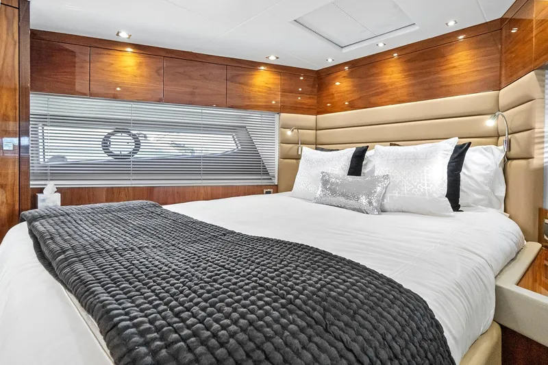 Slide: The Image of Luxurious bedroom interior of 2019 Sunseeker Manhattan 66 yacht with elegant wood paneling. - 21