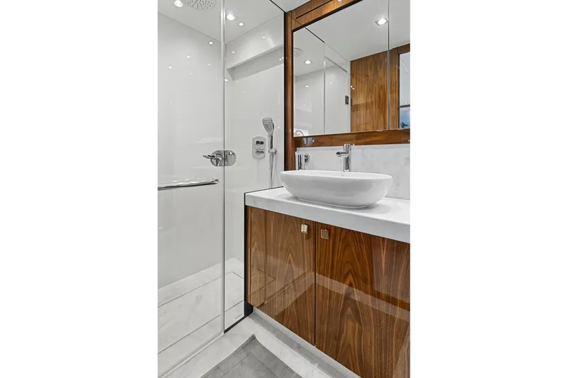 Slide: The Image of Luxurious bathroom in 2019 Sunseeker Manhattan 66 yacht with modern fixtures and wood accents. - 28