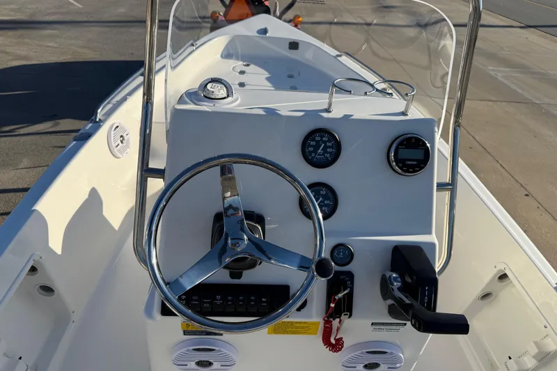 Slide: The Image of 2026 Key West 1720 Center Console boat dashboard with steering wheel and gauges. - 12