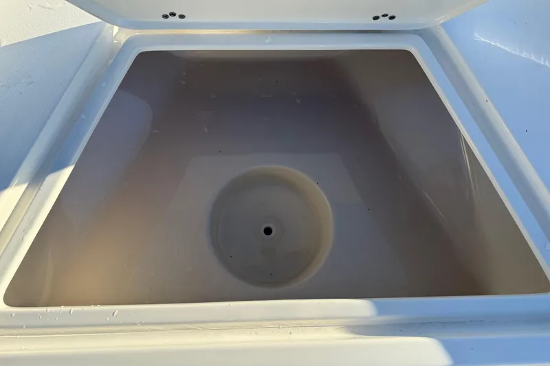 Slide: The Image of Open storage compartment on 2026 Key West 1720 Center Console boat. - 19