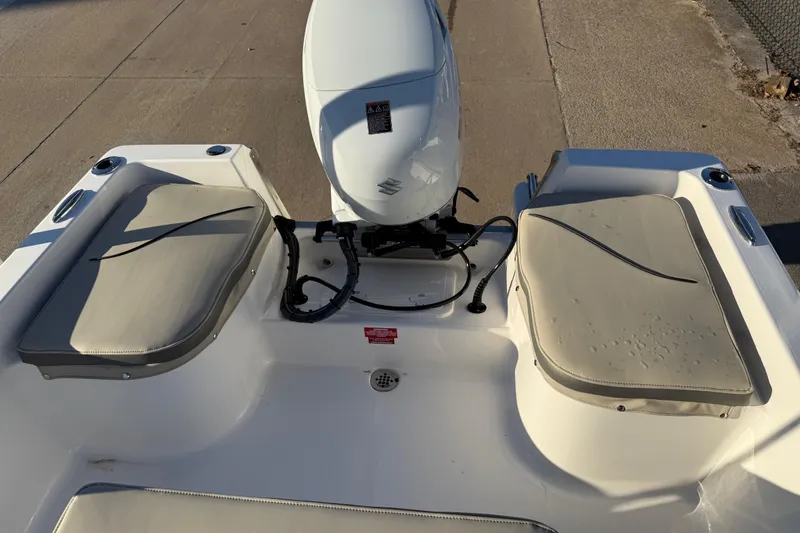 Slide: The Image of 2026 Key West 1720 Center Console boat with cushioned seating and outboard motor. - 22