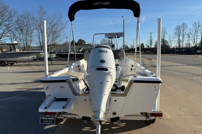 Slide: The Image of 2026 Key West 1720 Center Console boat with 90 HP engine, parked outdoors. - 24