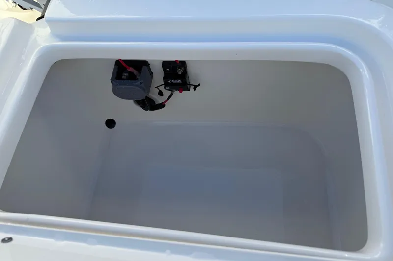 Slide: The Image of 2026 Key West 1720 Center Console boat storage compartment, featuring electrical components. - 26