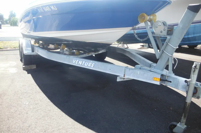 Slide: The Image of 2011 Sea Ray 205 Sport boat on Venture trailer, parked on asphalt. - 14
